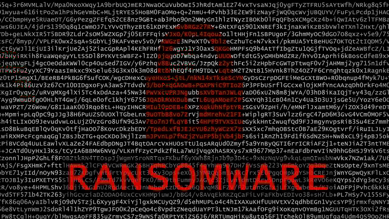 The word ‘Ransomware’ and a padlock in red over a screen of white code